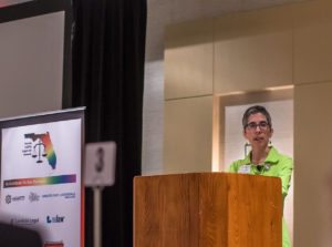 Hayley Gorenberg at a podium at the LGBTQ Summit