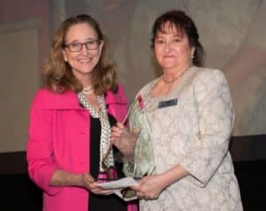 Sharon Bourassa, right, accepts the Jane Elizabeth Curran Distinguished Service Award from Foundation board member Karen Buesing.