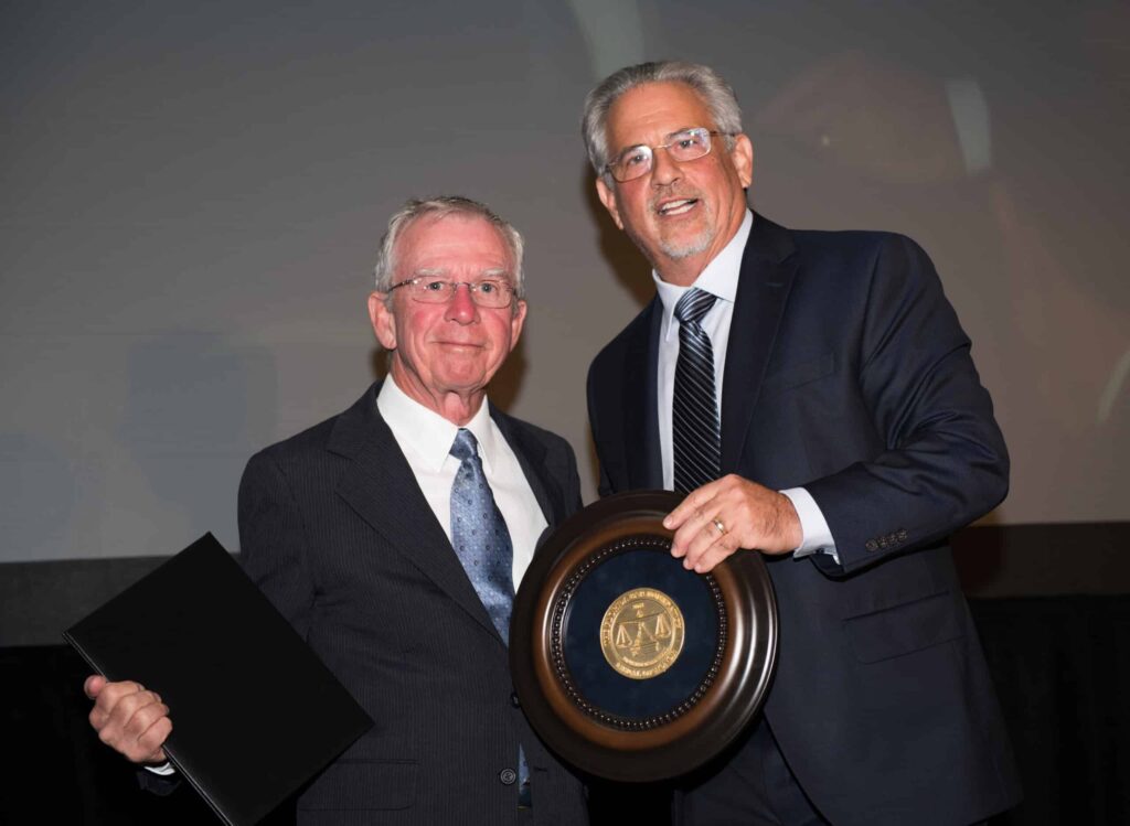 Howard Talenfeld, right, accepts the 2018 Medal of Honor for a Lawyer award from Florida Lawyers Mutual Insurance Company board member Dudley Goodlette.